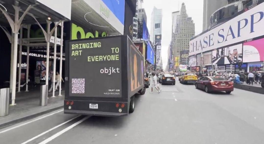 The OBJKT screen truck driving through Times Square